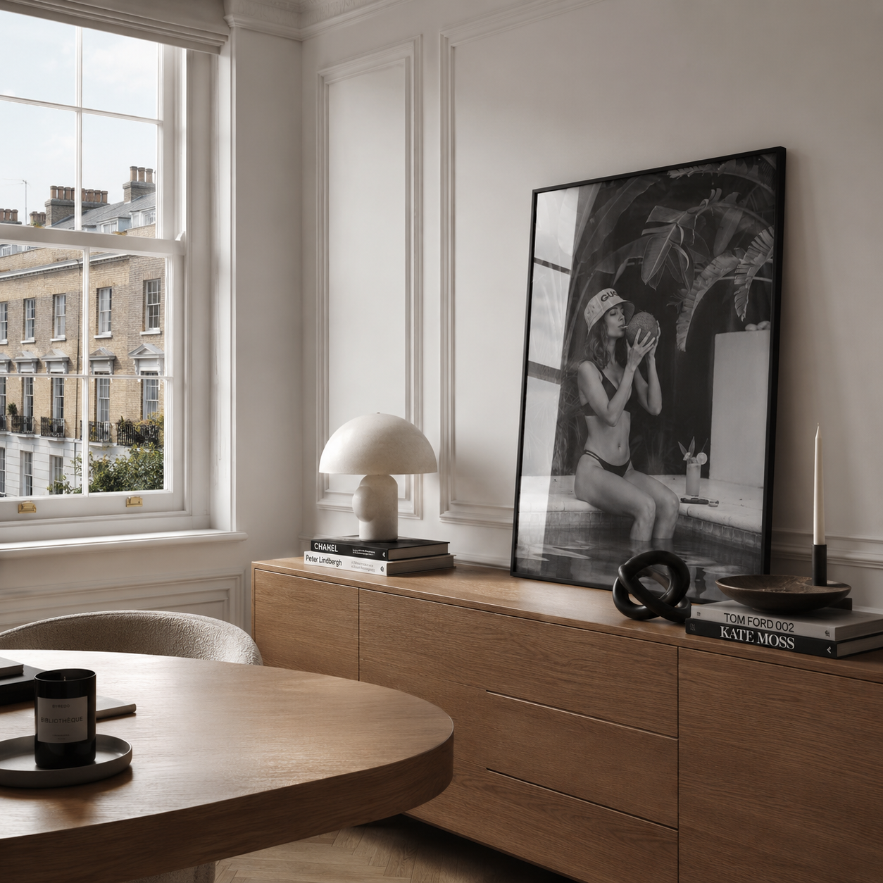 Modern interior with wooden dresser, books, and a large window.