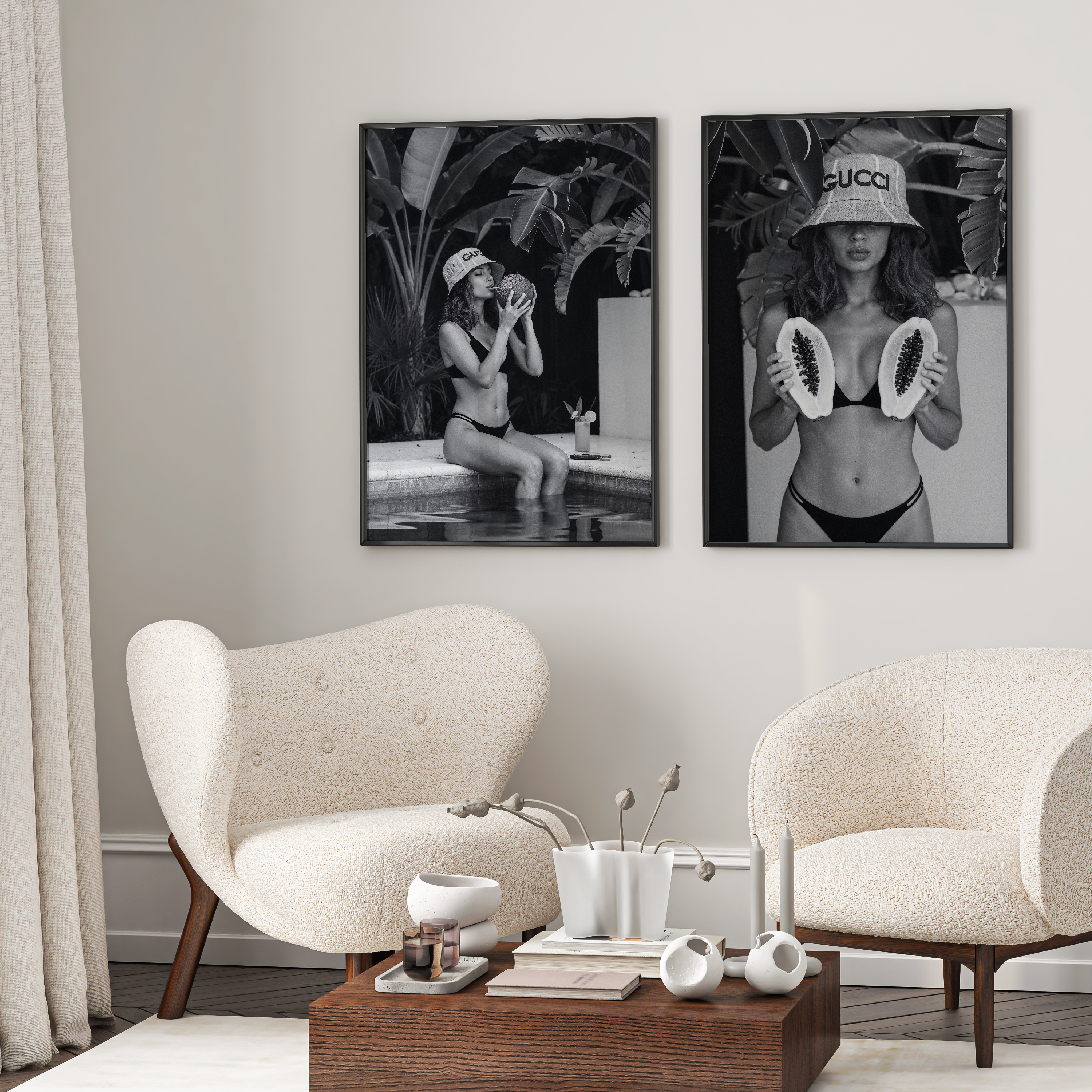 Modern living room with two white chairs, a coffee table, and two black and white artworks on the wall.