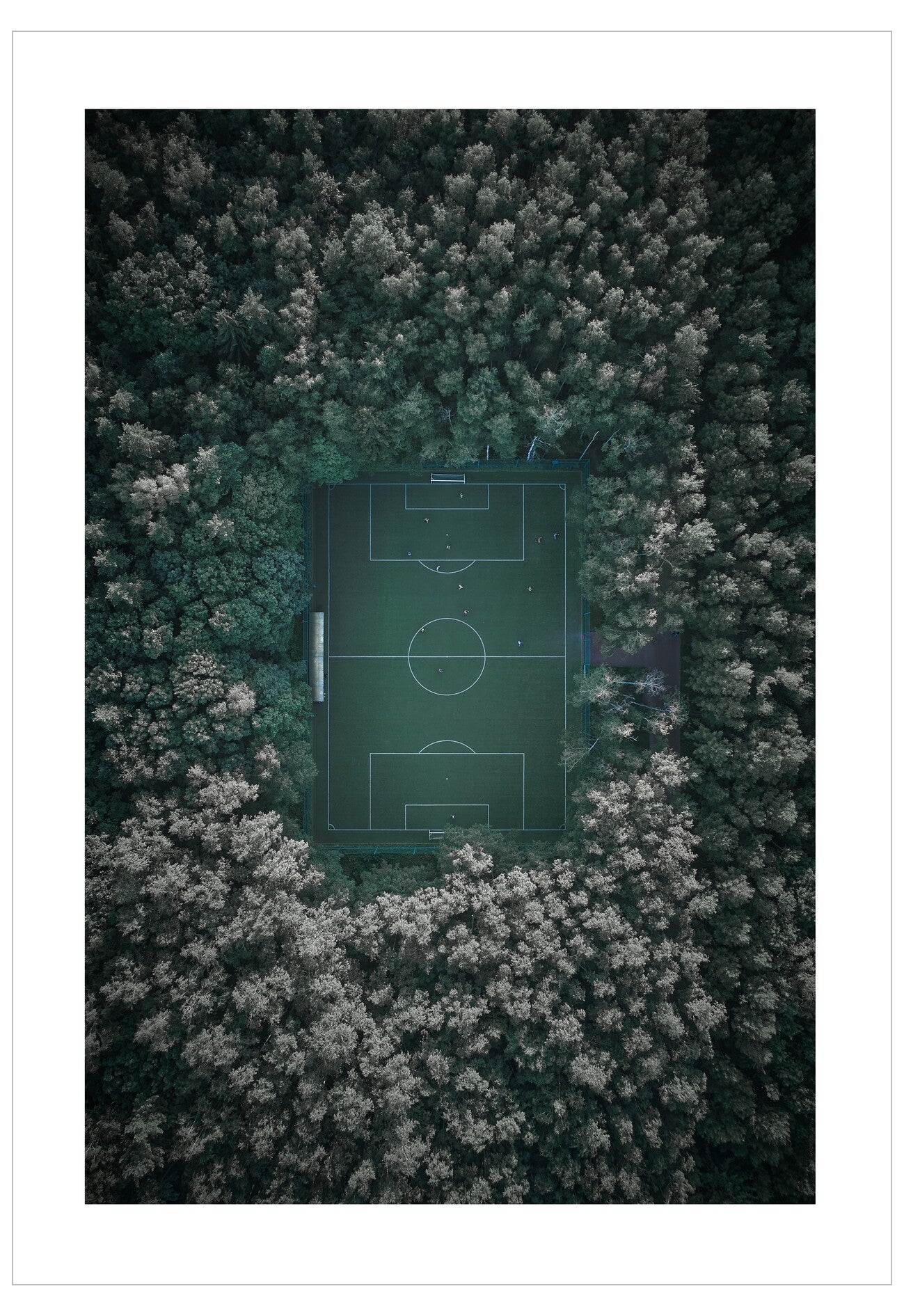 Aerial view of a soccer field surrounded by trees