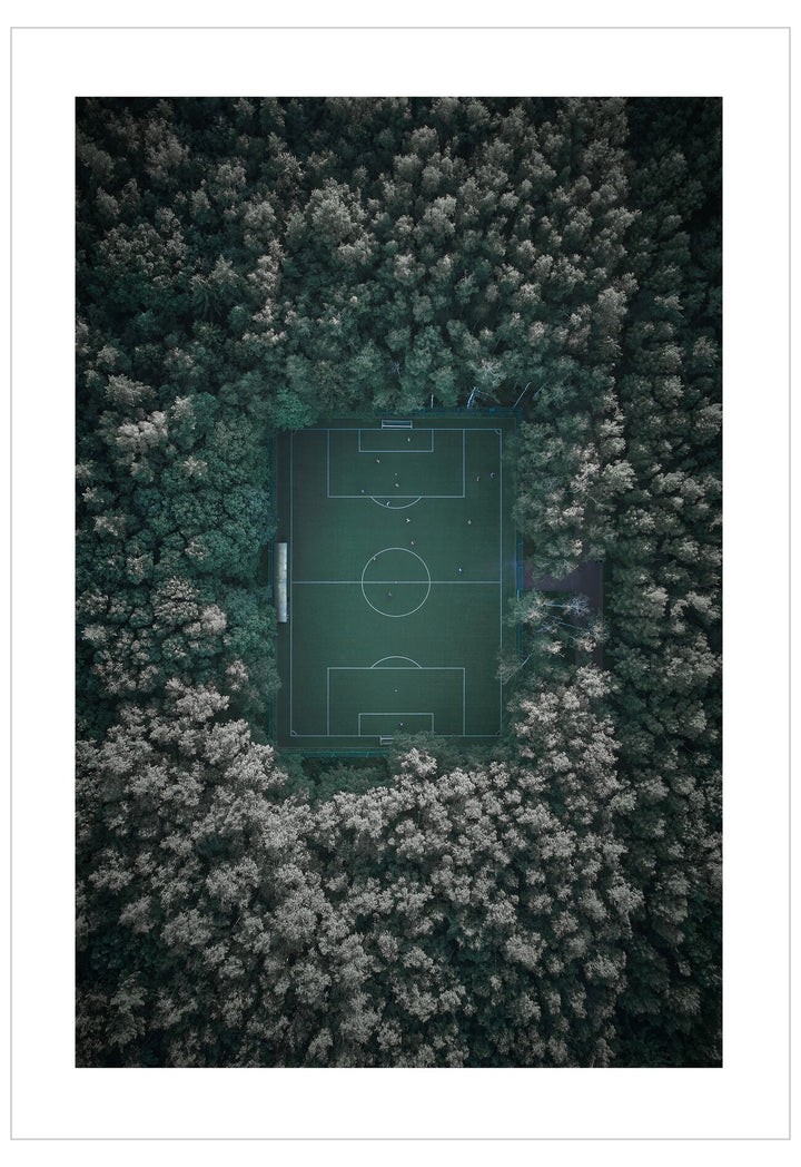 Aerial view of a soccer field surrounded by trees