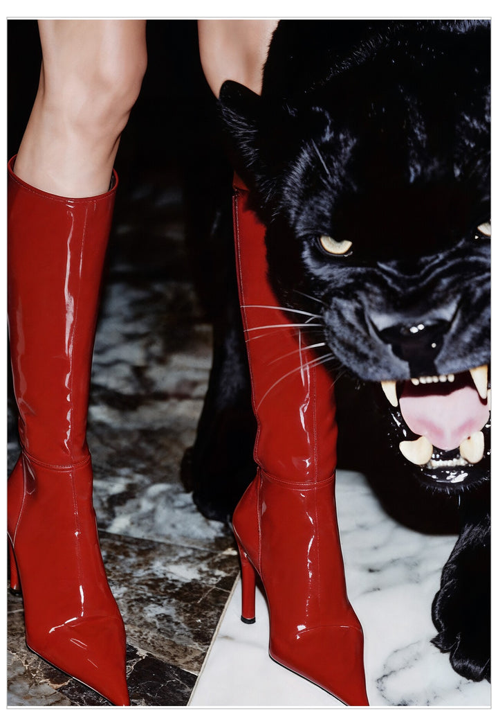 Red high-heeled boots with a black panther on a dark background