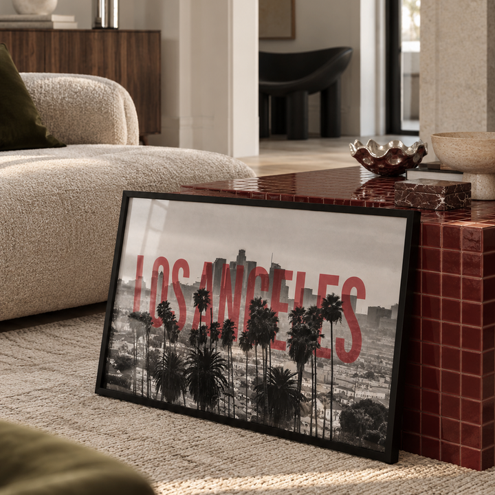 Los Angeles cityscape wall art featuring a black and white skyline with tall palm trees and large red 'LOS ANGELES' text across the center, shown on a white background.