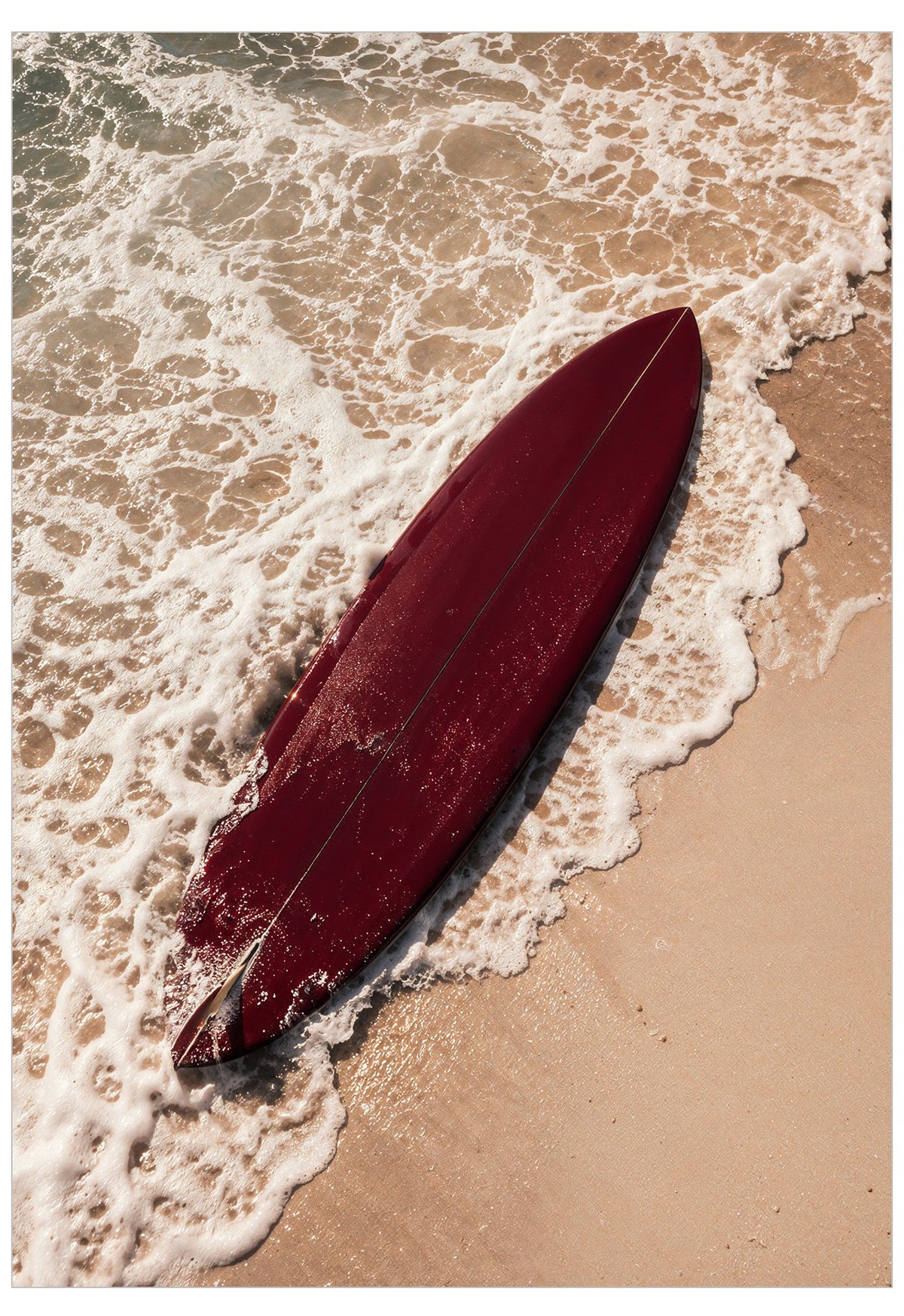 deep red surfboard on the beach
