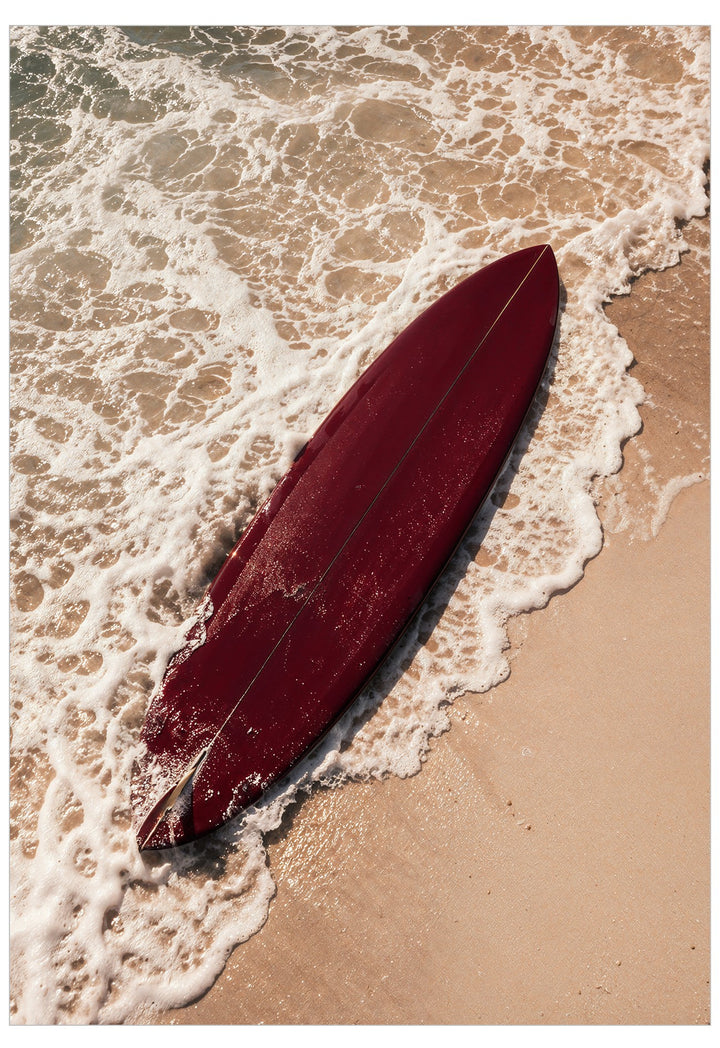 deep red surfboard on the beach