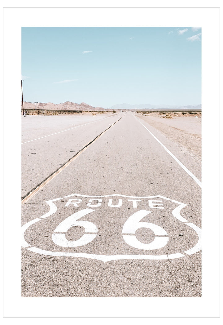 Route 66 sign on a desert road with clear sky