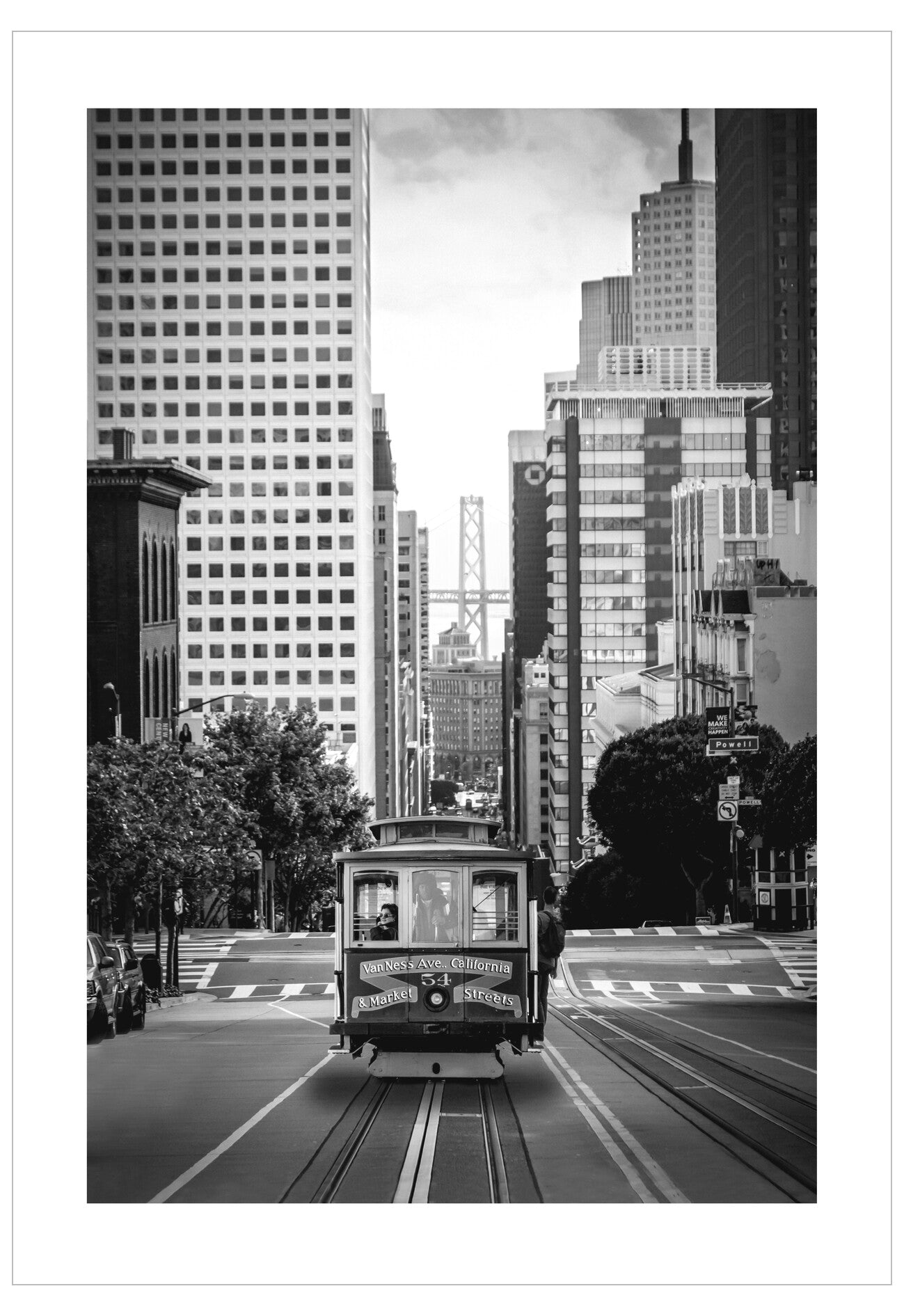 Vintage cable car on tracks with tall buildings in the background