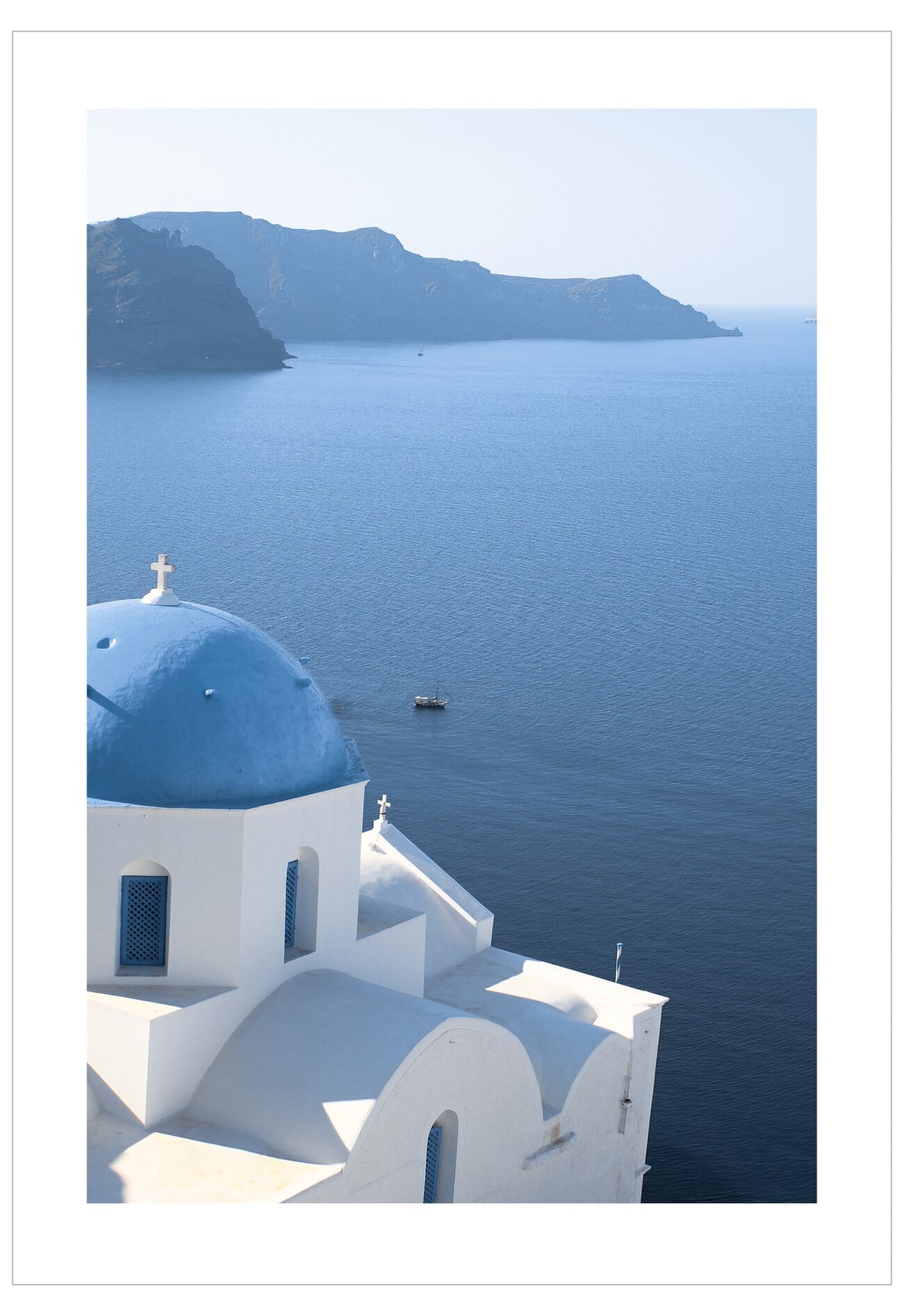 White building with blue dome by the sea
