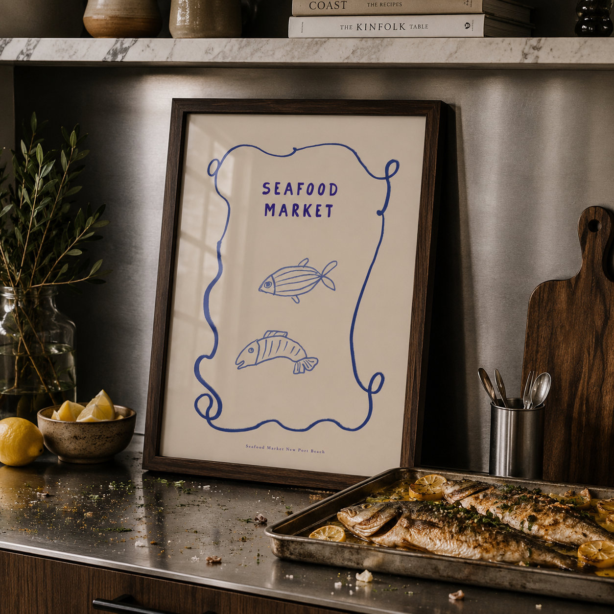 Framed artwork titled 'Seafood Market' on a kitchen counter with cooked fish.