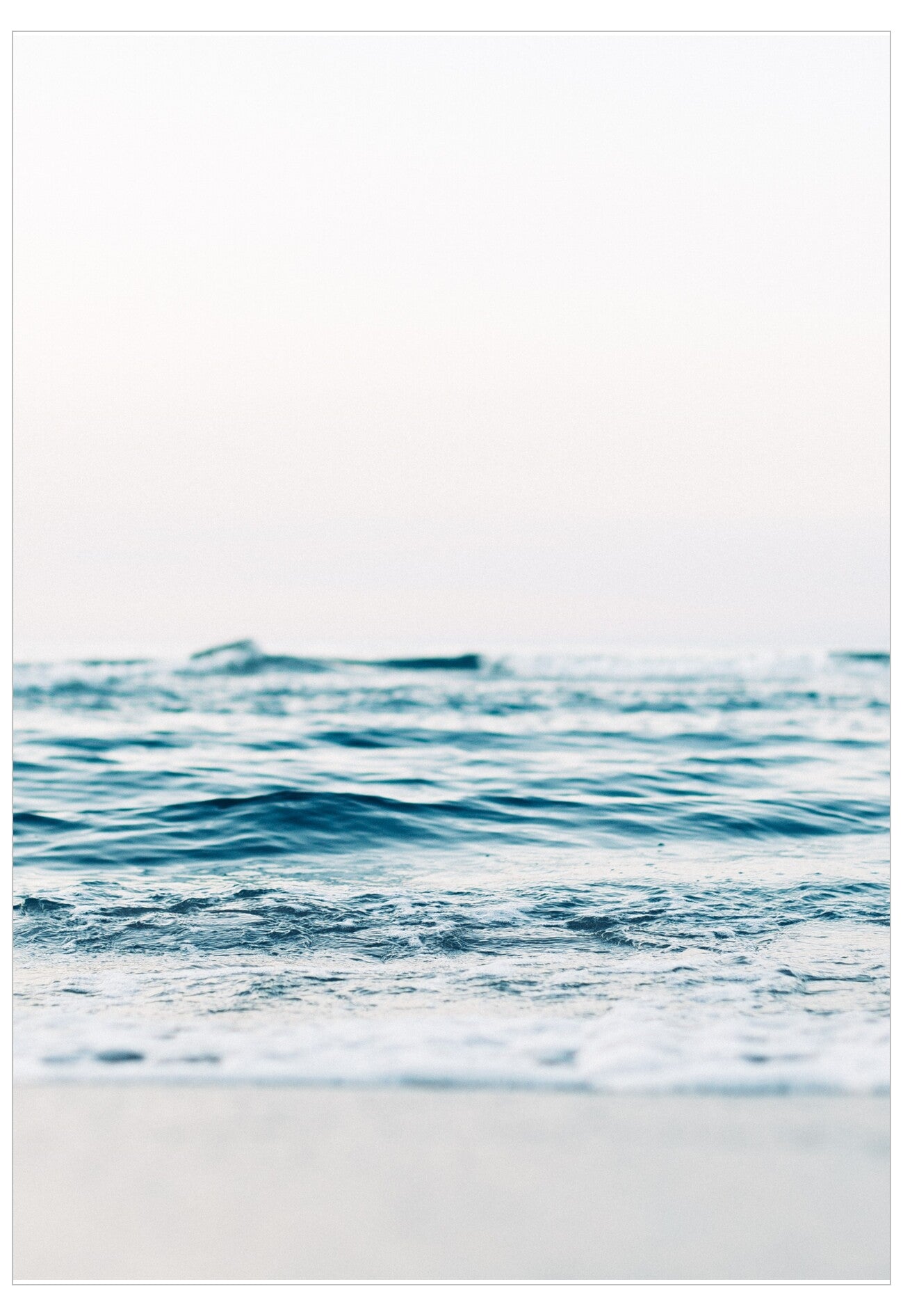 Calm ocean waves meeting a sandy beach