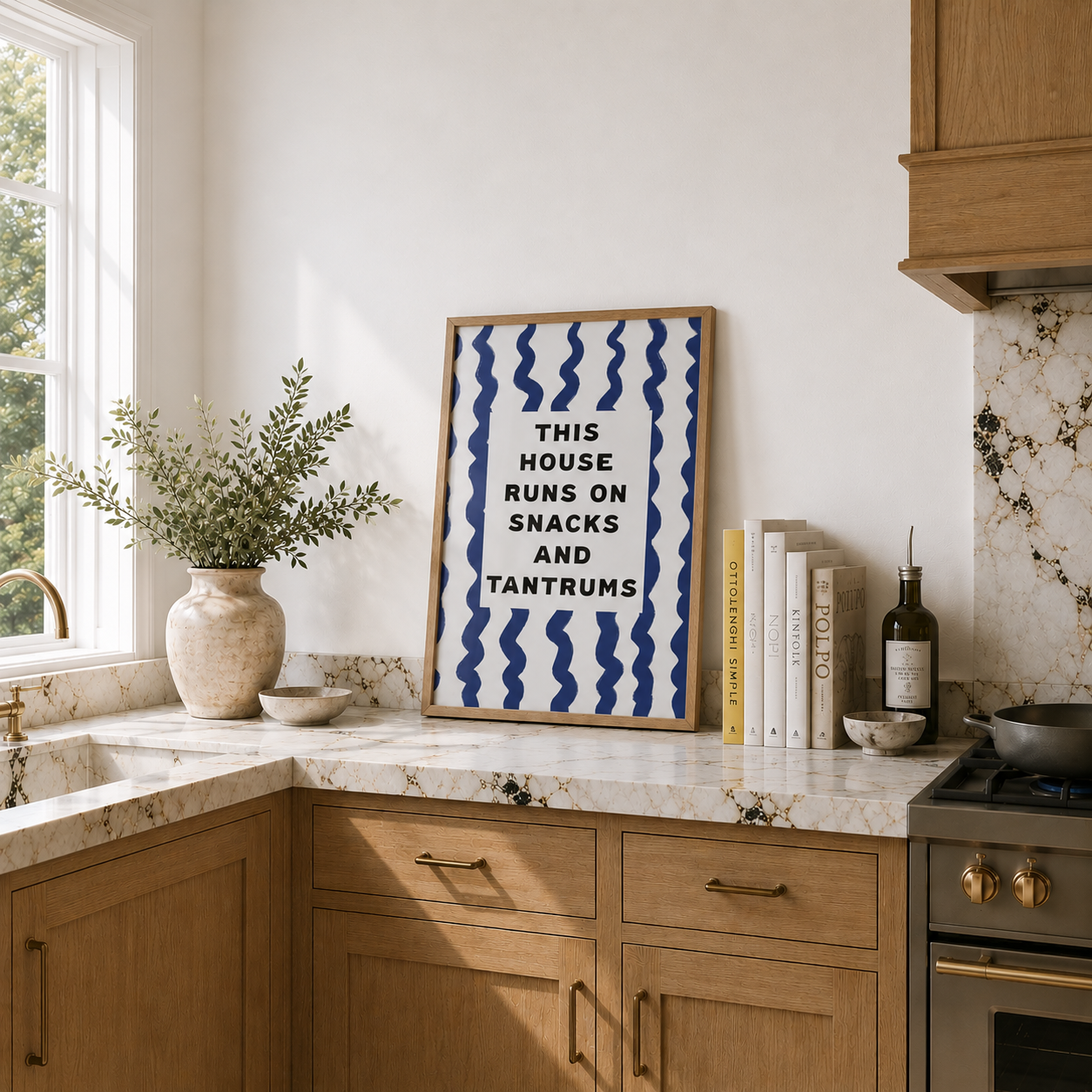 Kitchen interior with a framed print on the wall, books, and kitchen appliances.