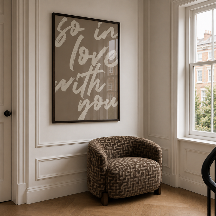 Patterned armchair in a room with a framed quote on the wall