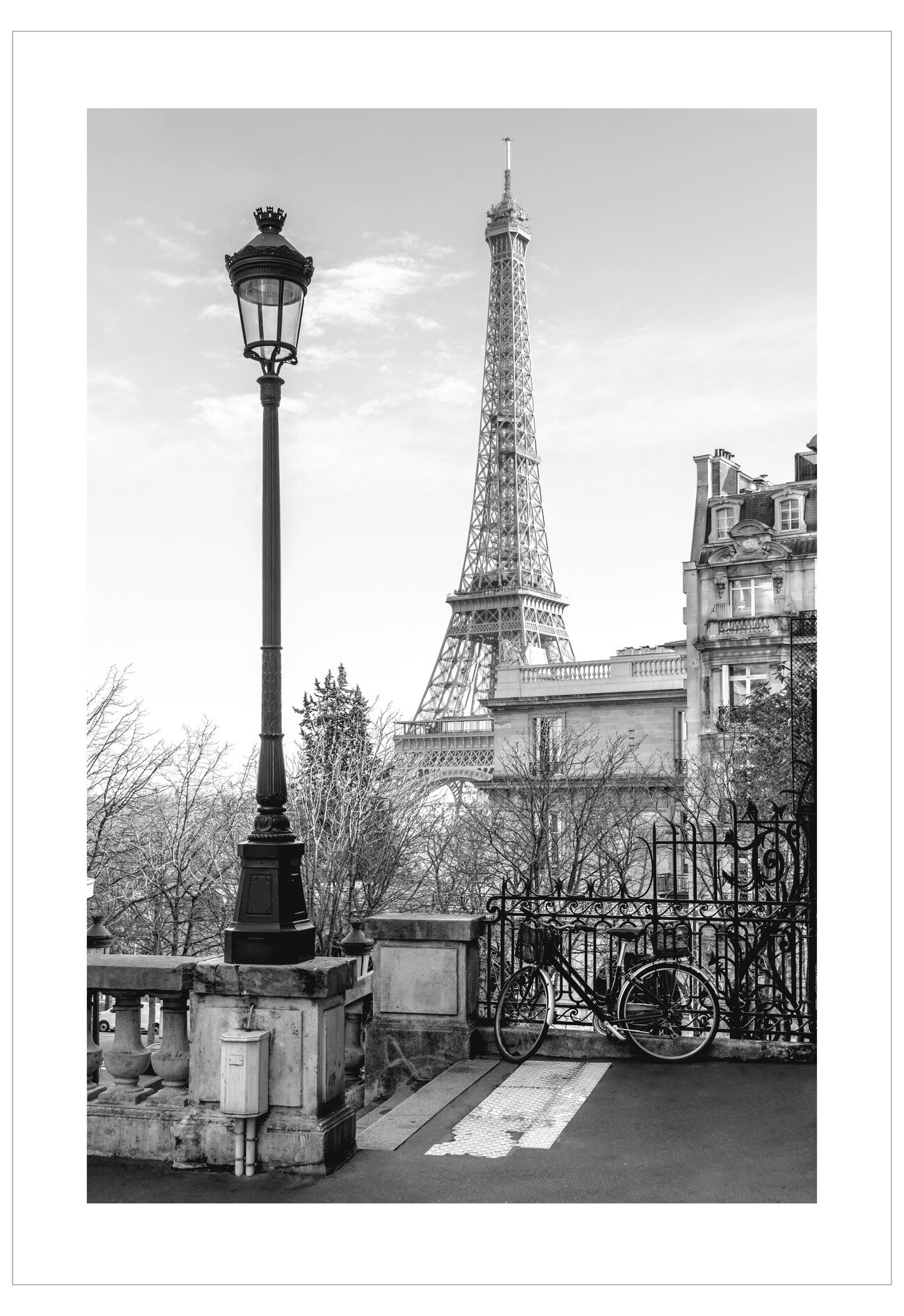 Black and white photo of the Eiffel Tower with a bicycle in the foreground.