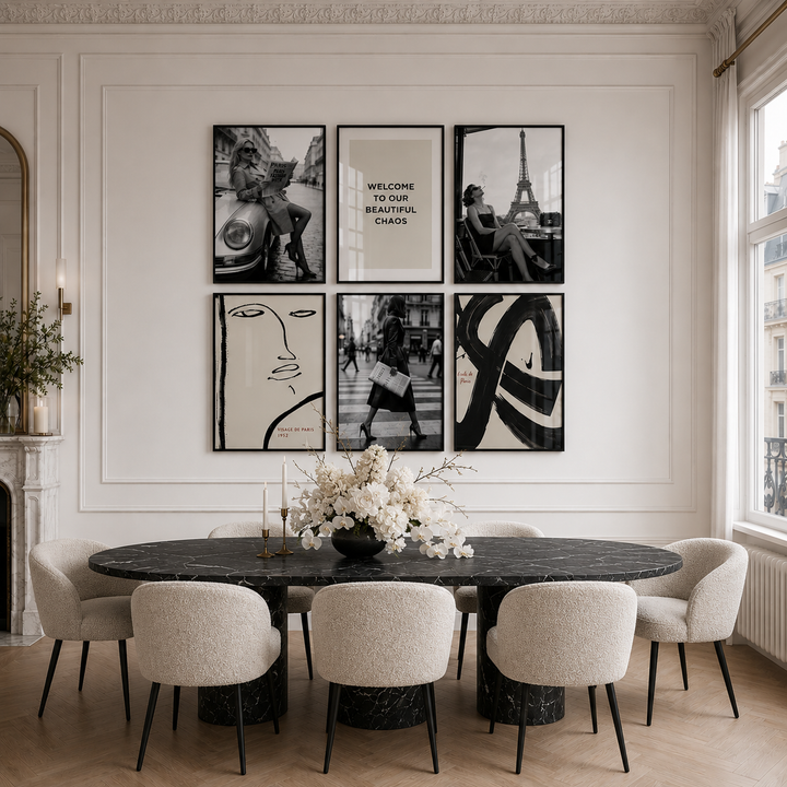 Dining room with a round table and chairs, featuring framed art on the wall.