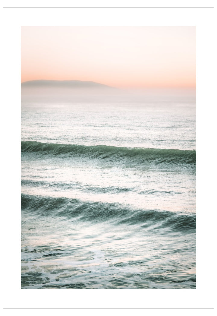 Ocean waves with a soft pink sky