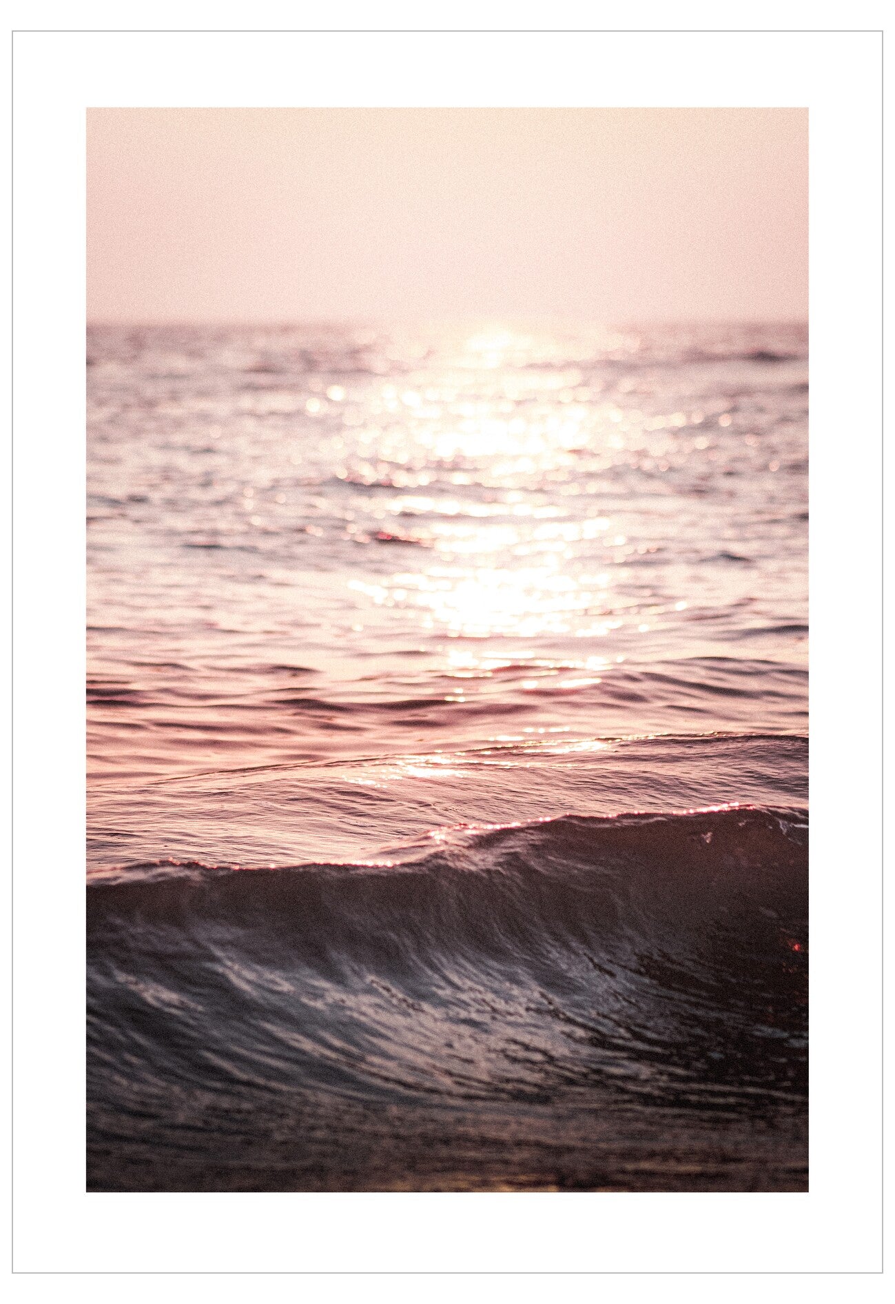 Sunset over water with pink and purple hues