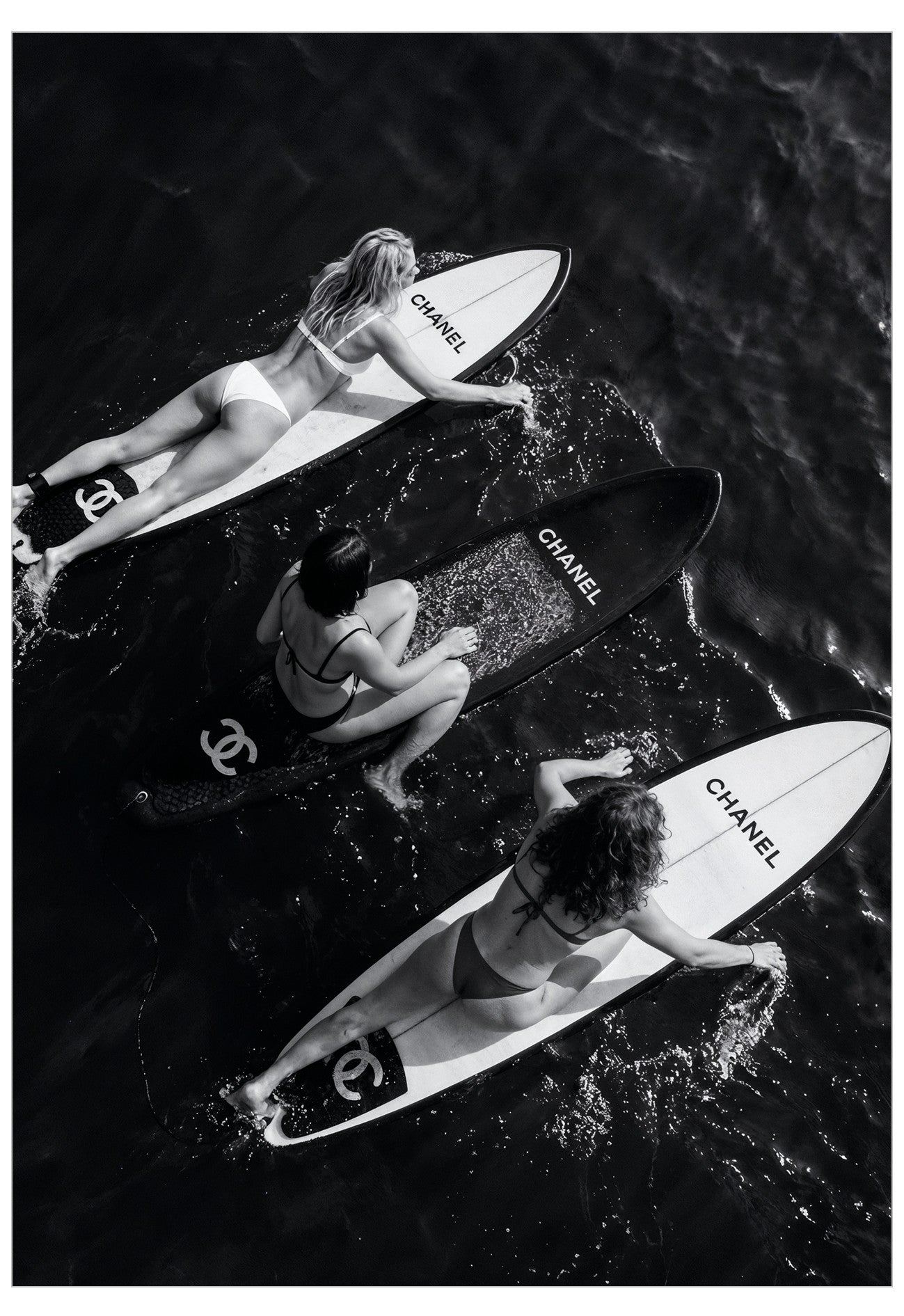 three woman surfing on designer surf boards