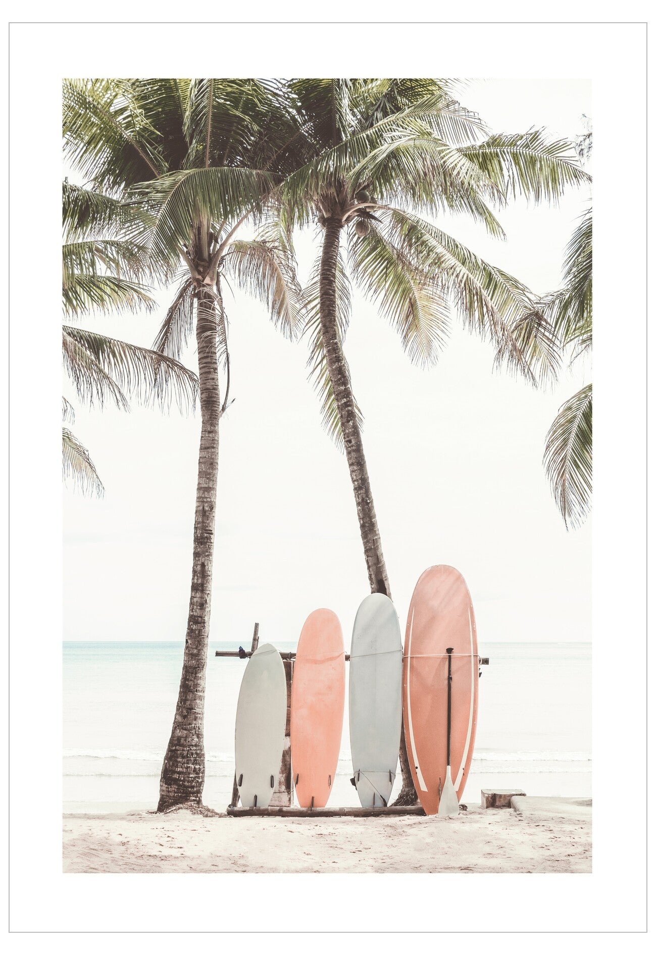 Colorful surfboards leaning against a wooden rack with palm trees in the background.