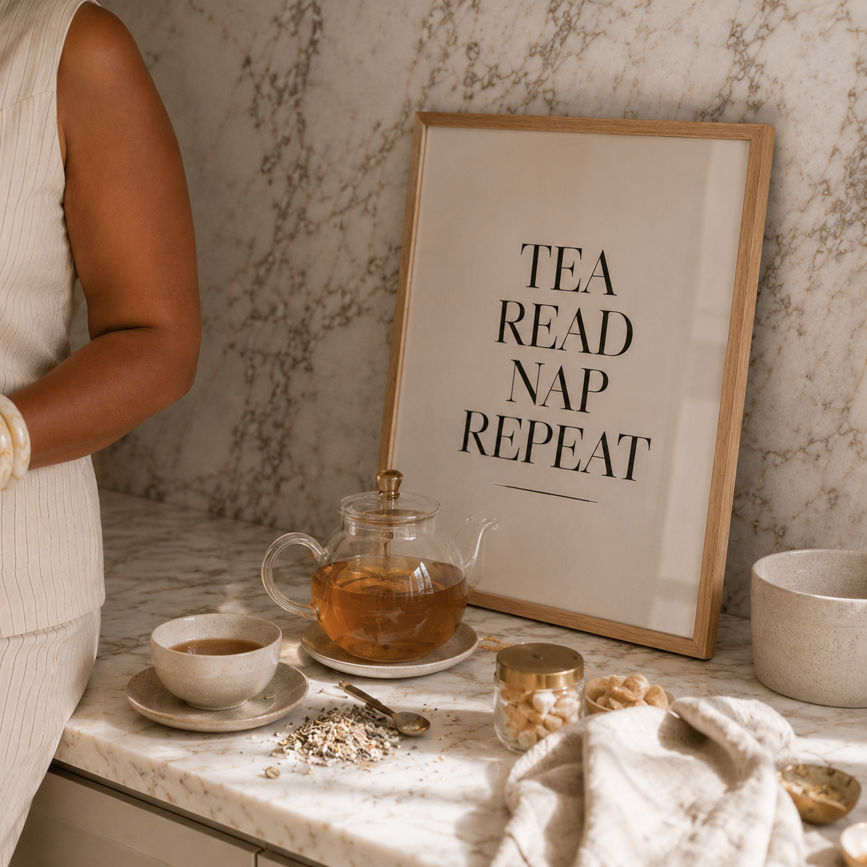 Tea set with a framed poster on a marble surface