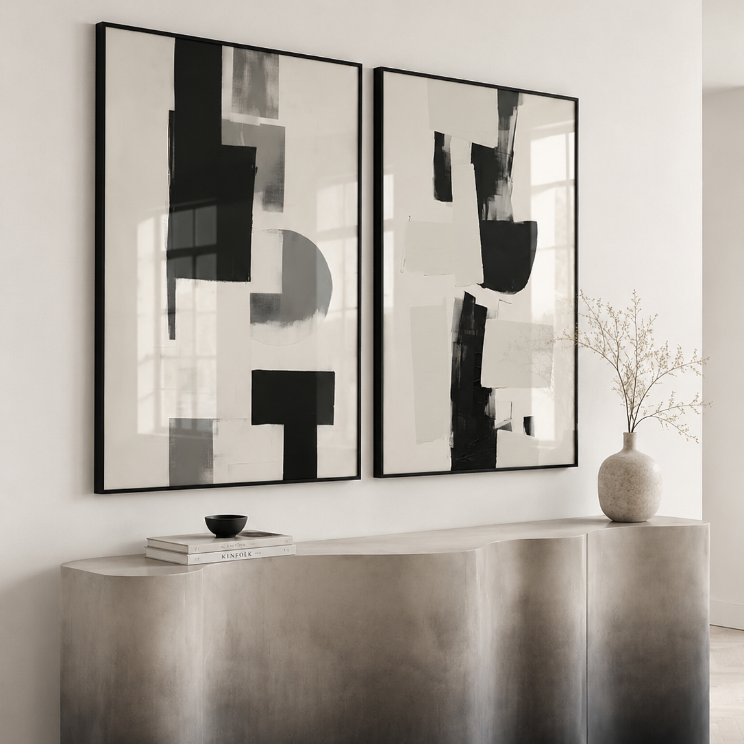 Modern interior with abstract black and white wall art above a metallic console table.