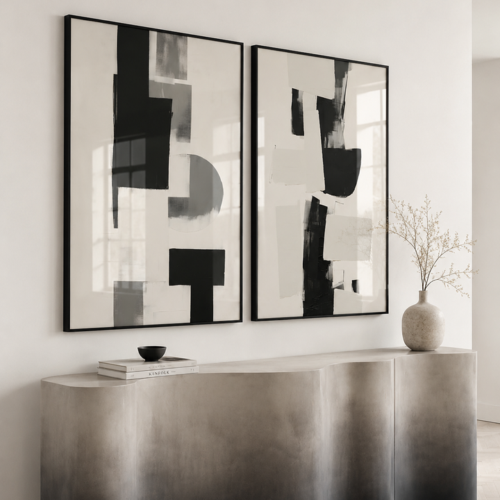 Modern interior with abstract black and white wall art above a metallic console table.