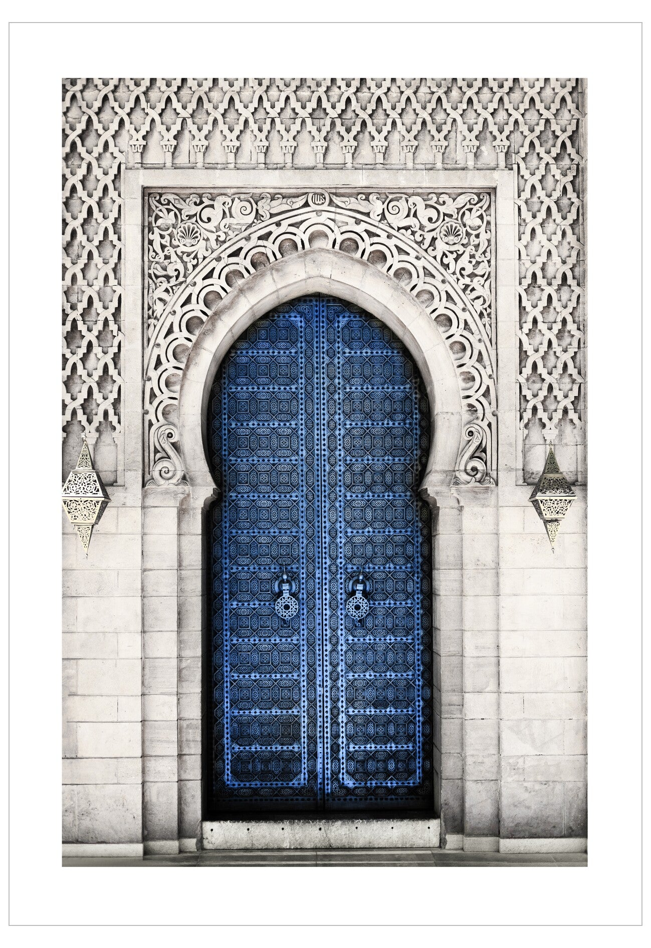 Decorative archway with intricate patterns and a blue door