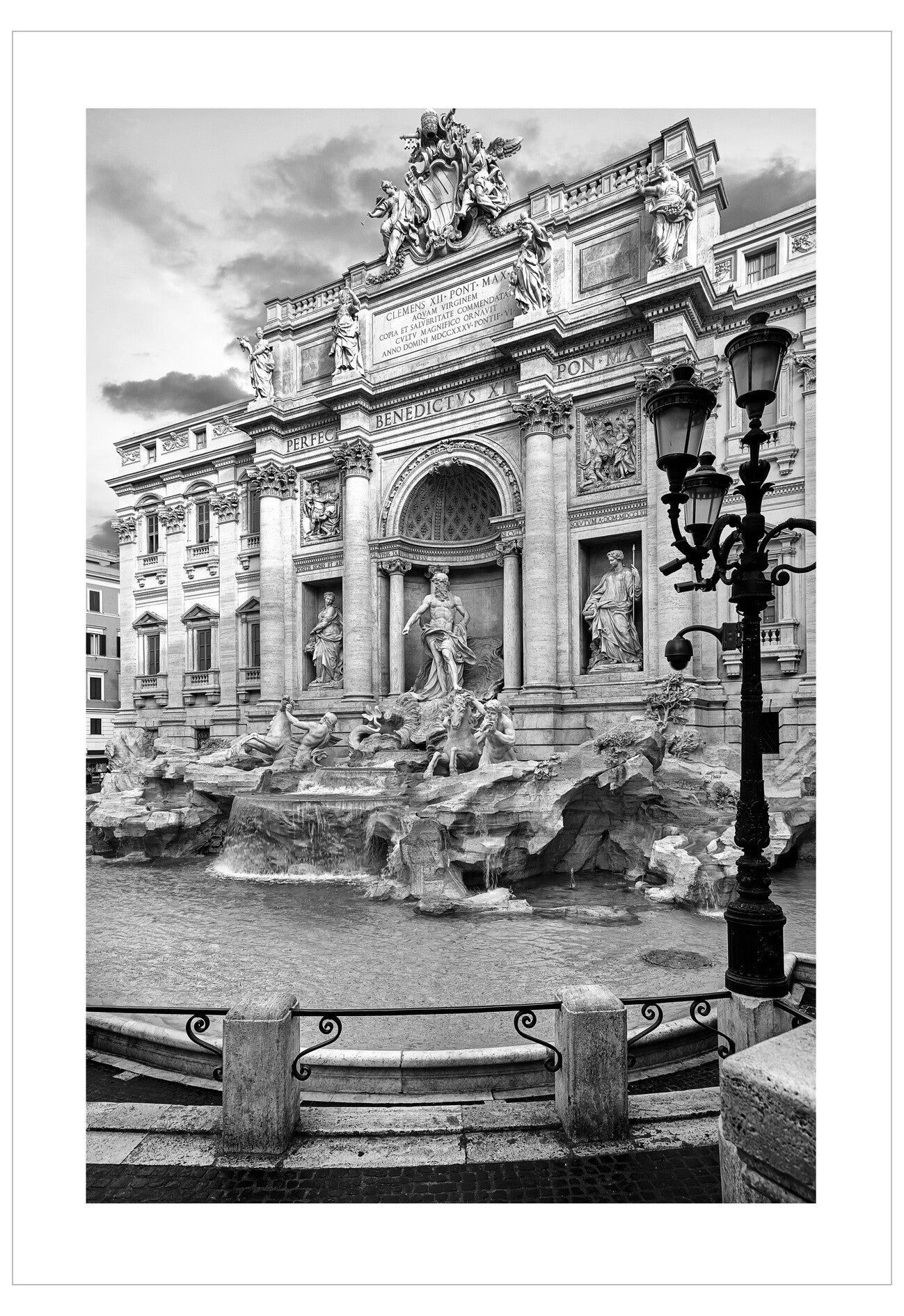 Black and white photograph of a classical fountain with statues and architectural elements.