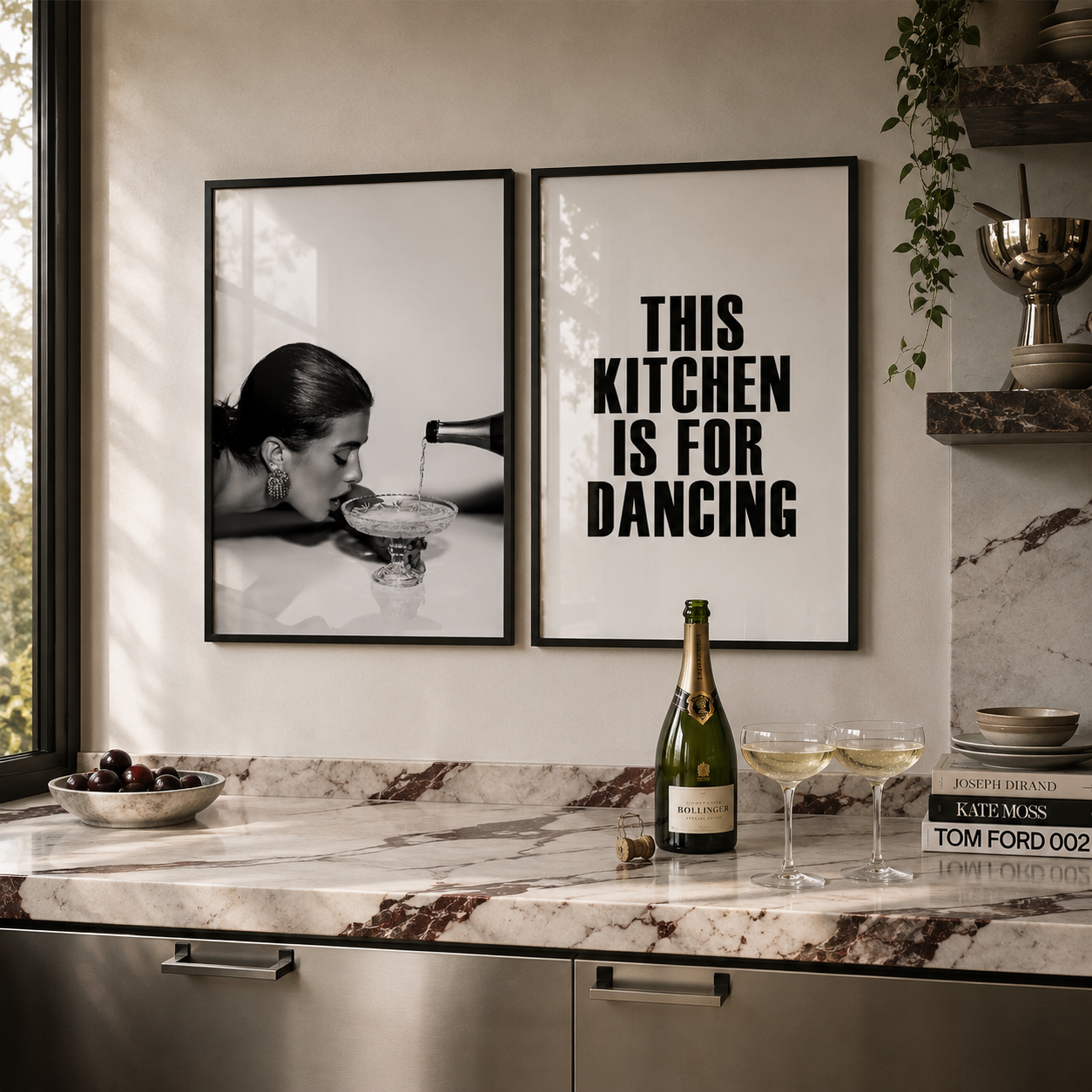 Modern kitchen with decorative posters and a bottle of champagne on a marble countertop.