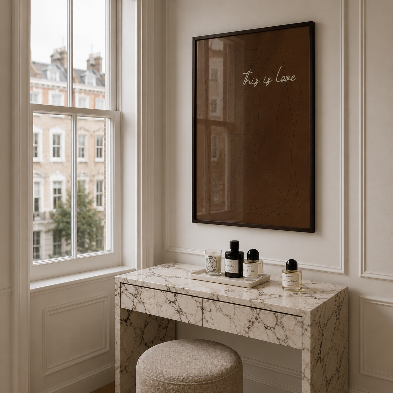 Marble vanity table with decorative items next to a window with a view of buildings.