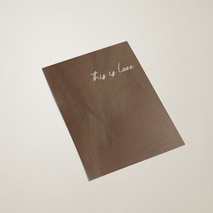Sheet of paper with 'this is love' text on a beige background