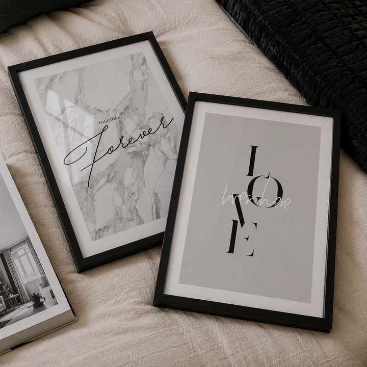 Two framed prints on a textured surface with 'Forever' and 'LOVE' text.