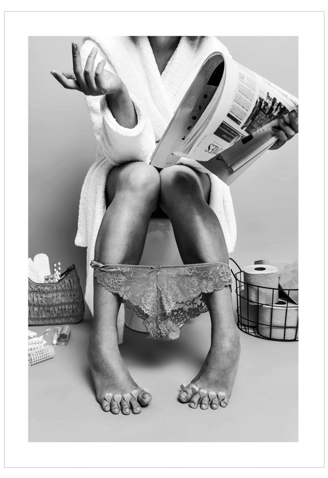 Person sitting on a toilet with a newspaper, surrounded by bathroom items.