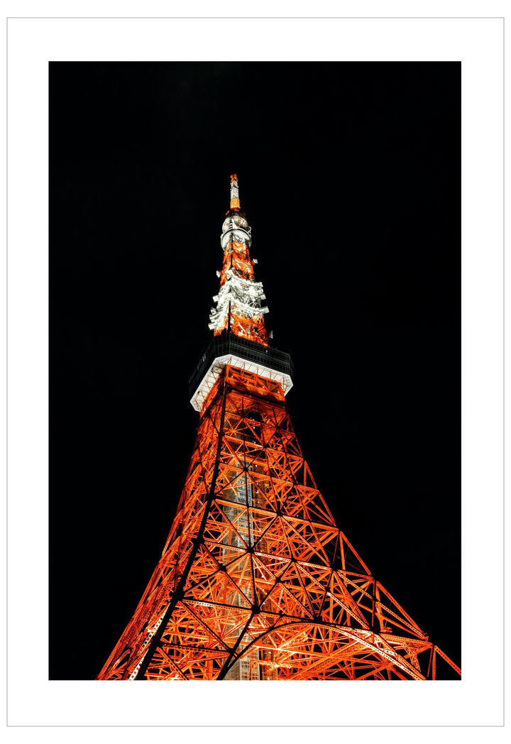 Tokyo Tower illuminated at night against a black sky