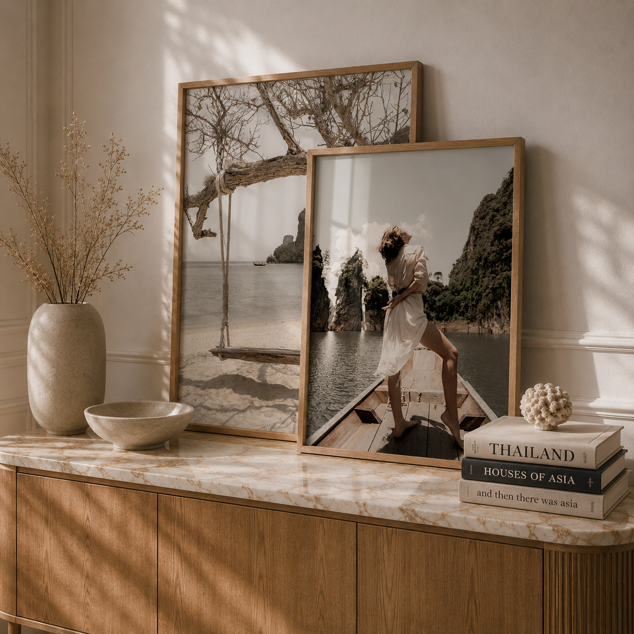 Two framed photographs on a wooden surface with books and decor items.