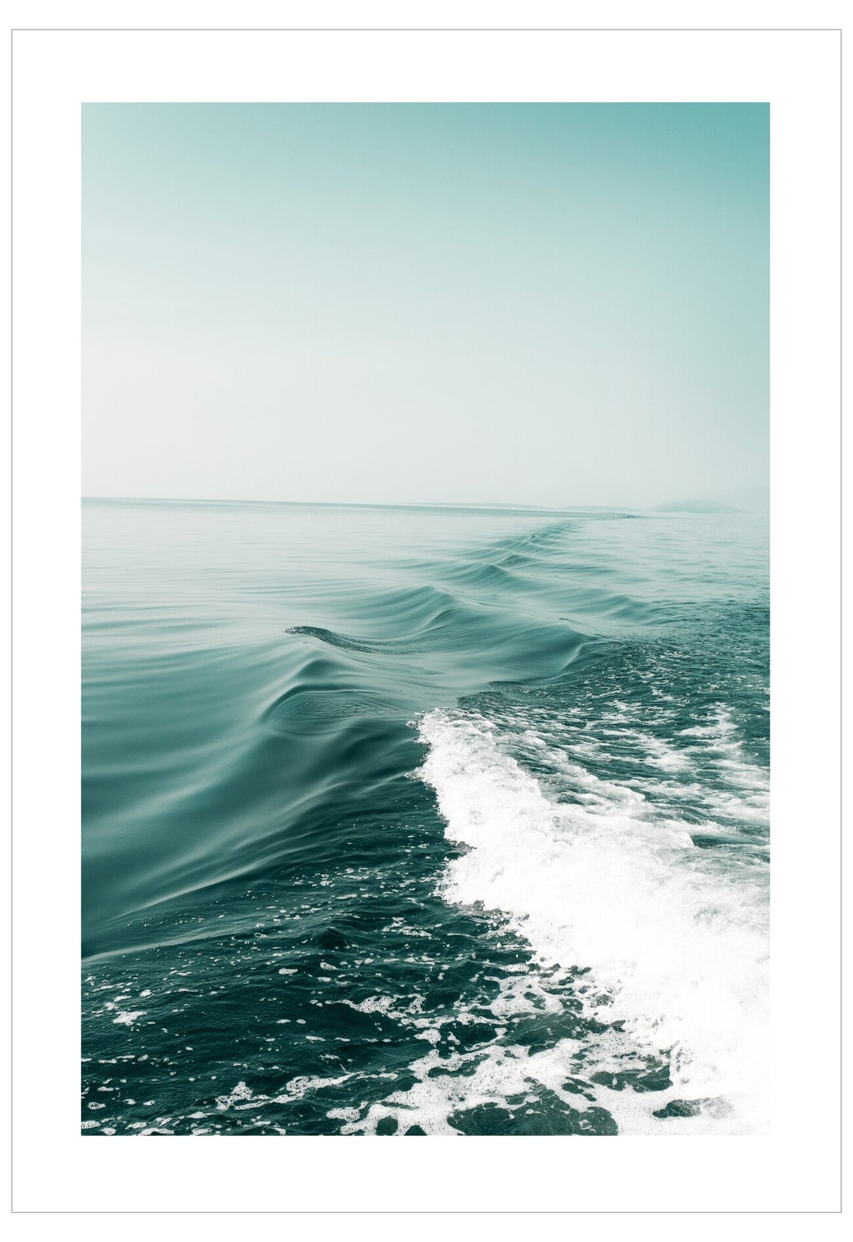 Wave in the ocean with white foam on a light blue background
