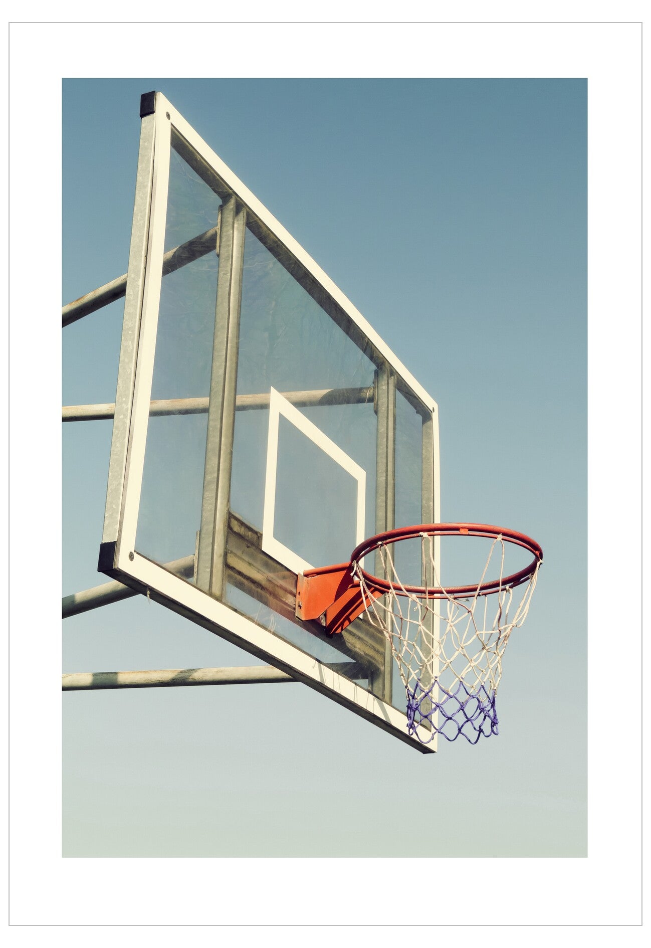 Basketball hoop against a clear blue sky