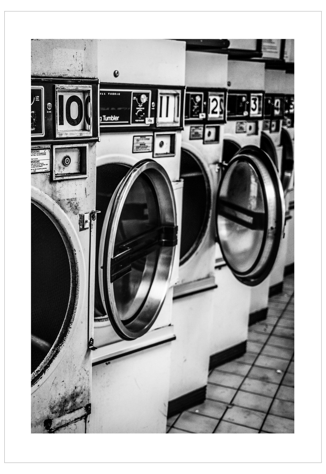 Row of vintage laundromat machines with numbered doors.