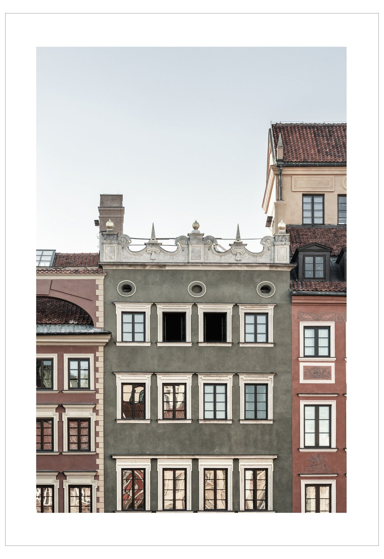 Traditional European building facades with architectural details against a clear sky.