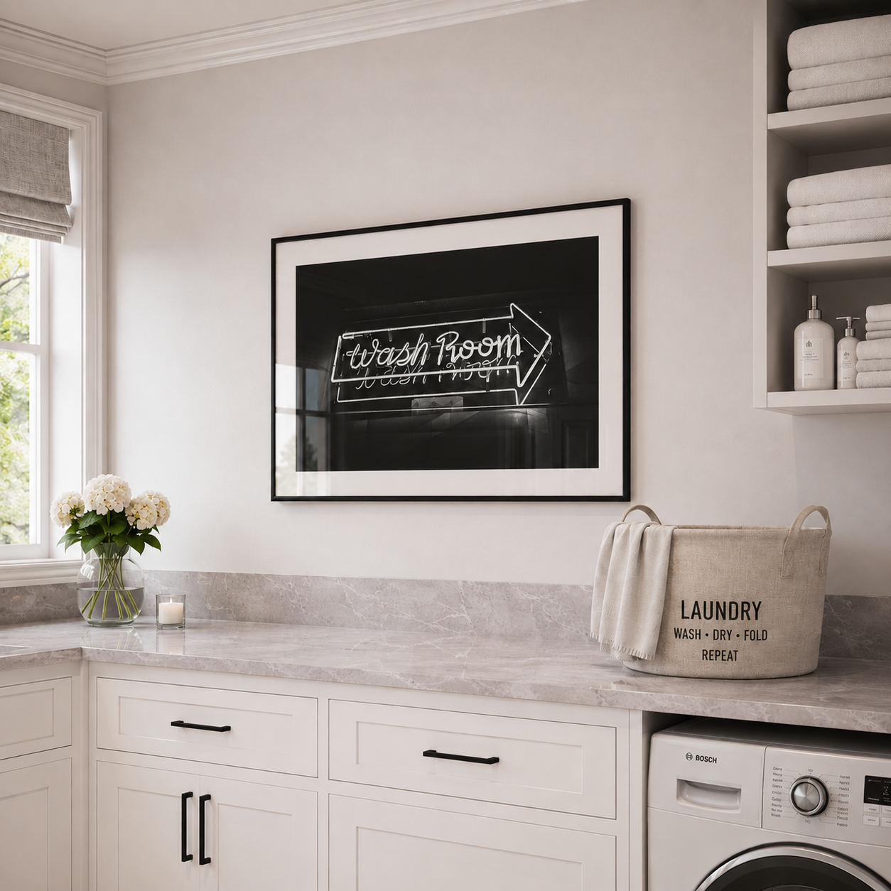 Laundry room with framed artwork, laundry basket, and washing machine.