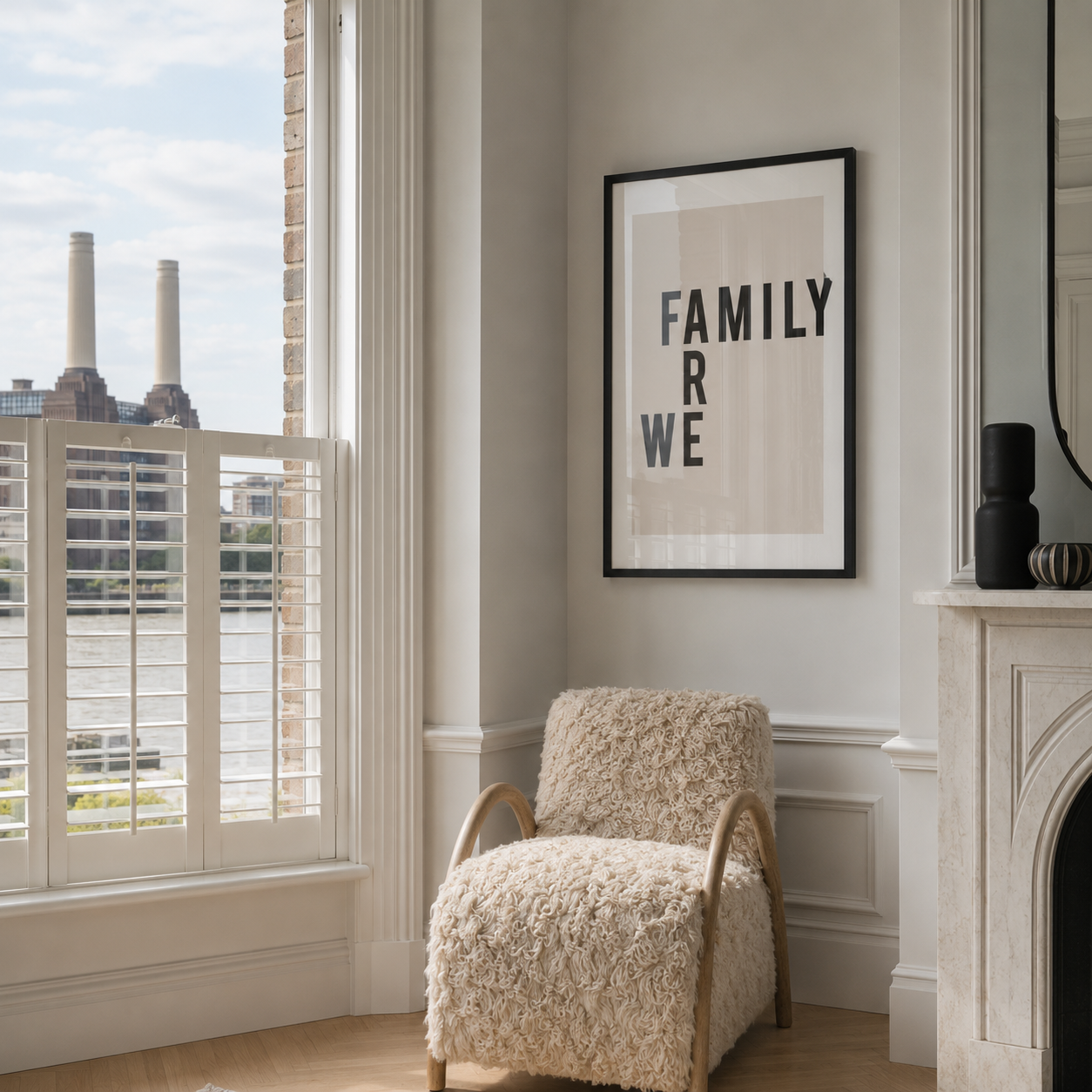 Cozy living room with a textured armchair, framed artwork, and large window.