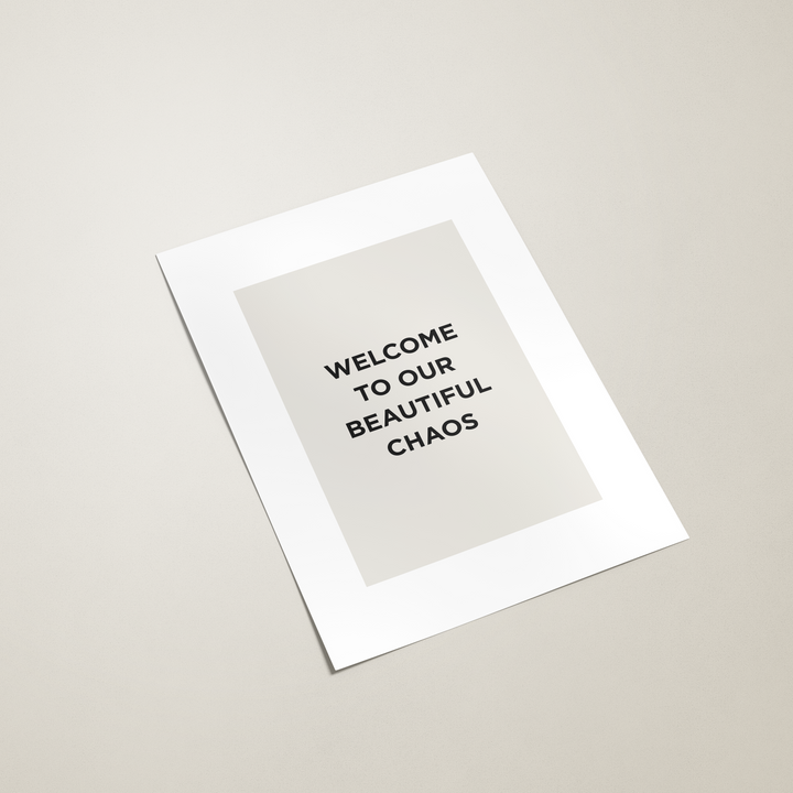 White print with text 'WELCOME TO OUR BEAUTIFUL CHAOS' on a beige background