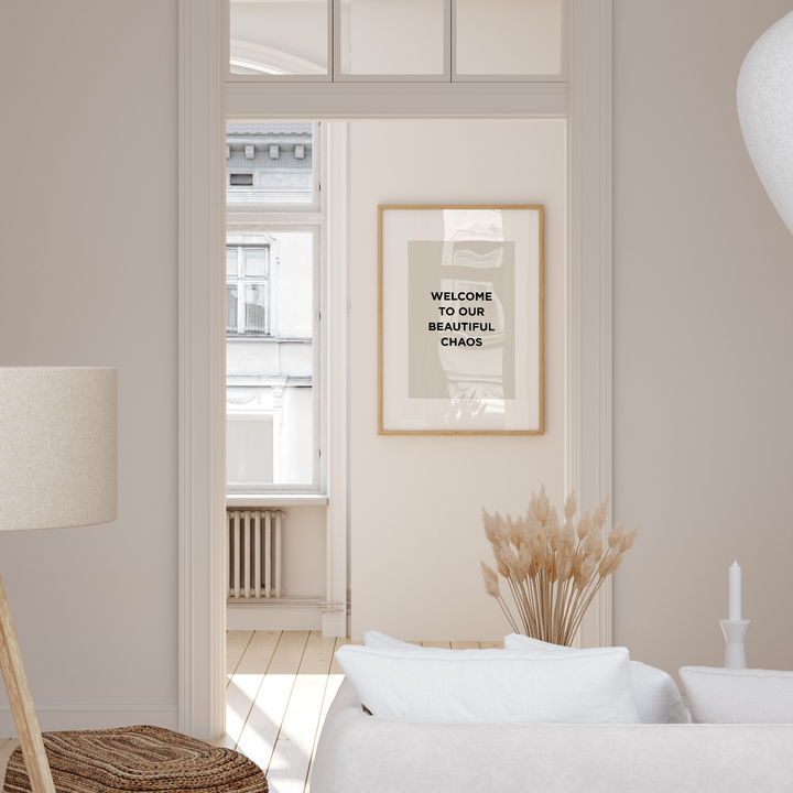 Modern living room with a framed quote on the wall, white sofa, and decorative elements.