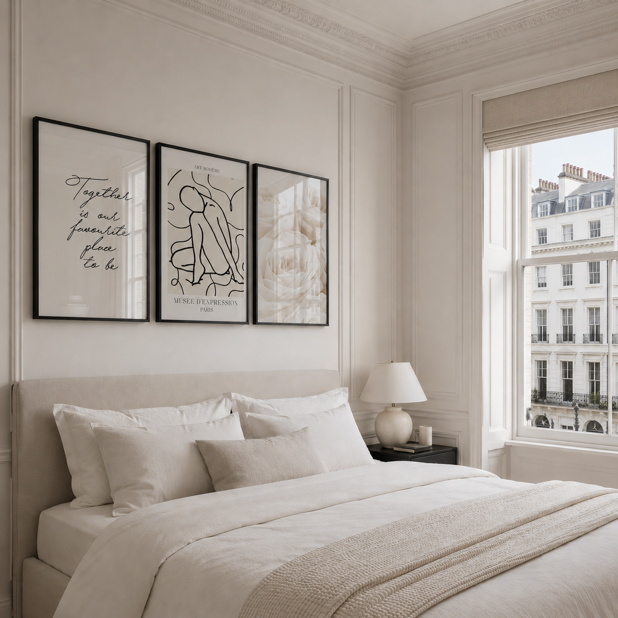 Neatly made bed in a bedroom with wall art and a window view.