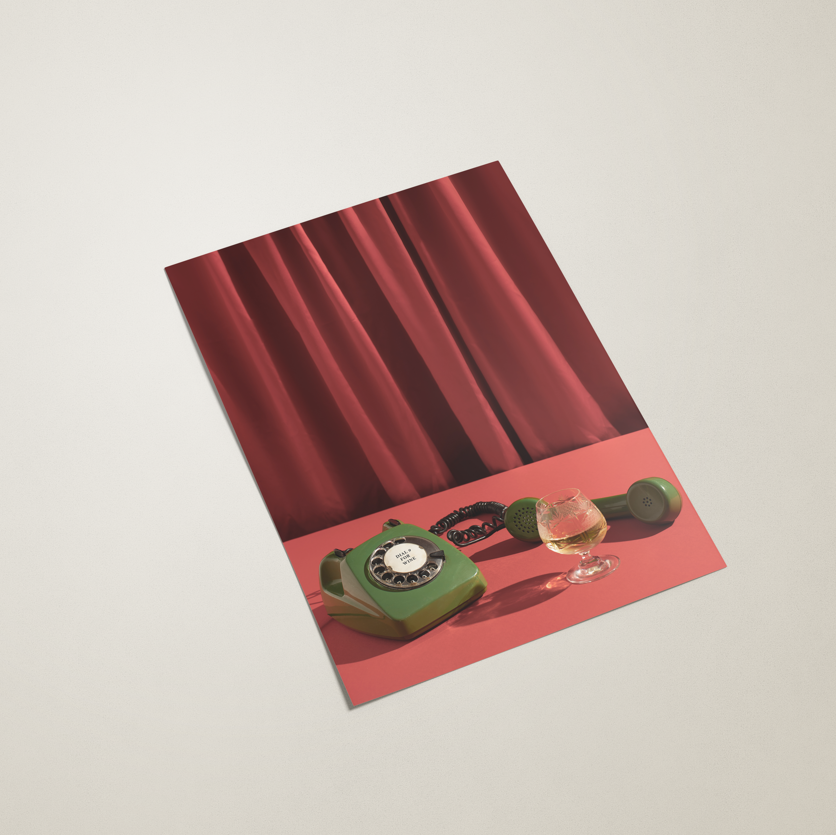 Red poster with a vintage green telephone and red rose on a beige background