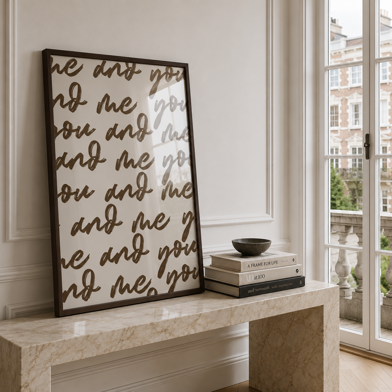 Decorative wall art with text on a marble ledge by a window