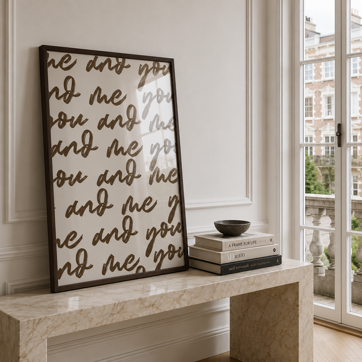Decorative wall art with text on a marble ledge by a window
