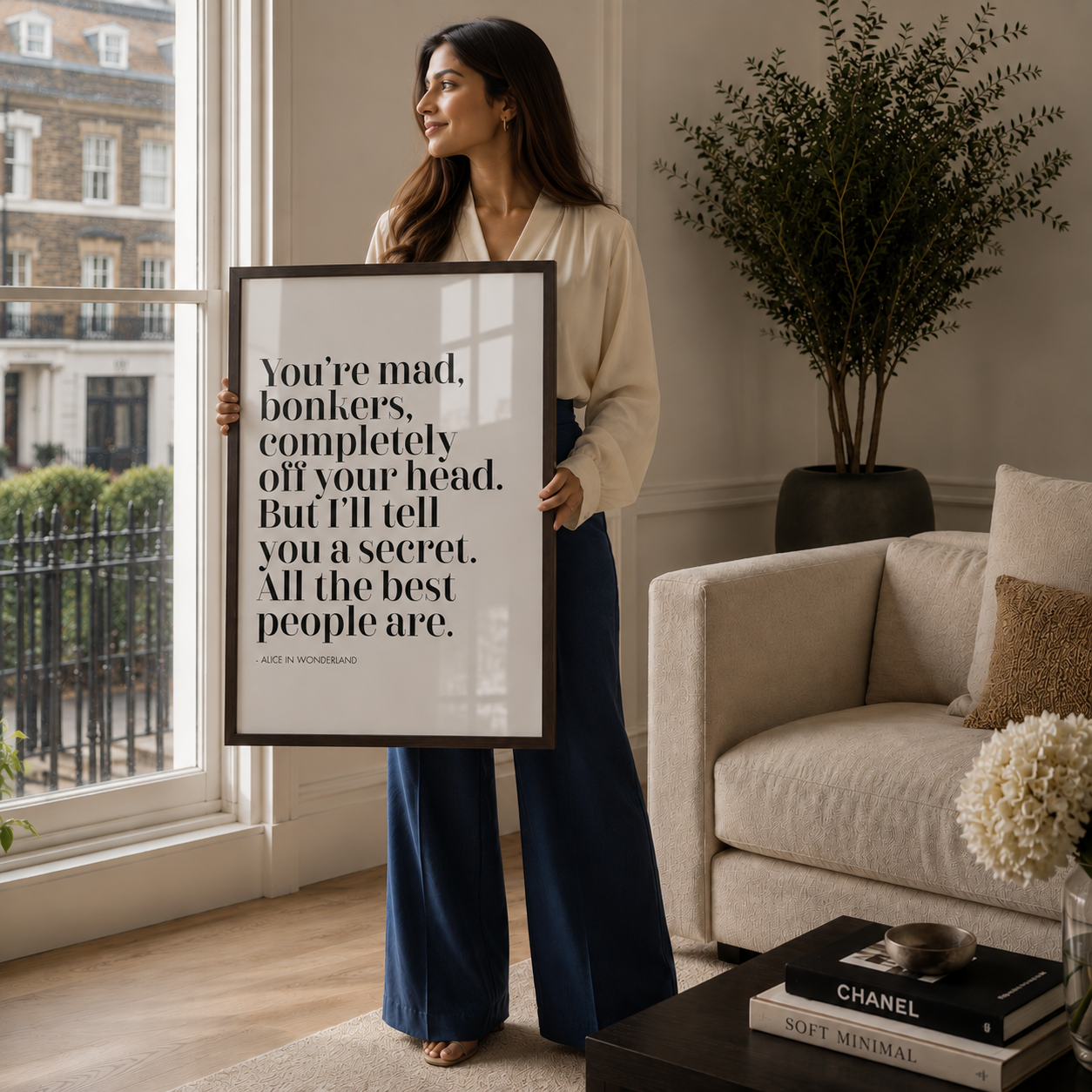 Woman holding a framed quote in a living room