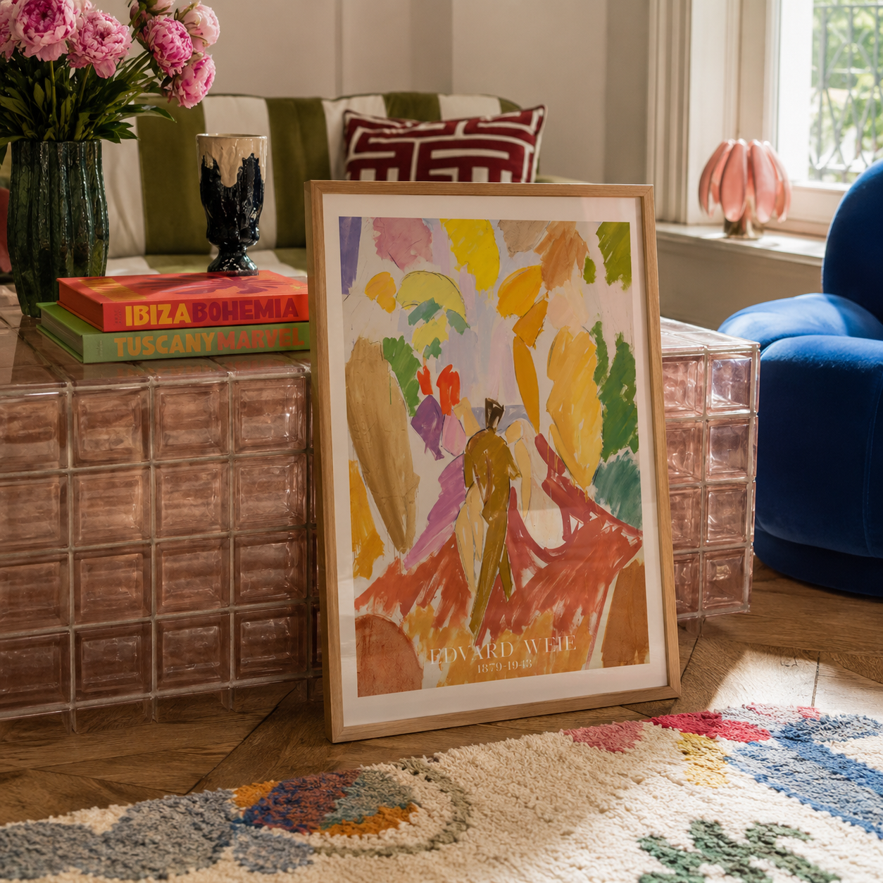 A framed abstract art print titled 'Edward Wise' leaning against a glass block side table in a beautifully styled living room.