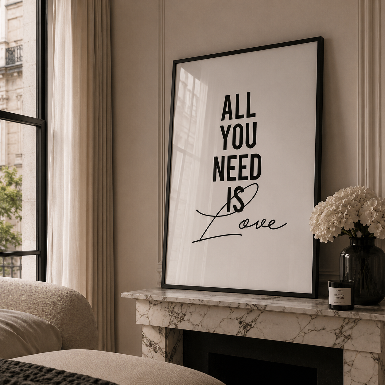 Framed artwork with 'All You Need Is Love' on a mantelpiece in a living room.