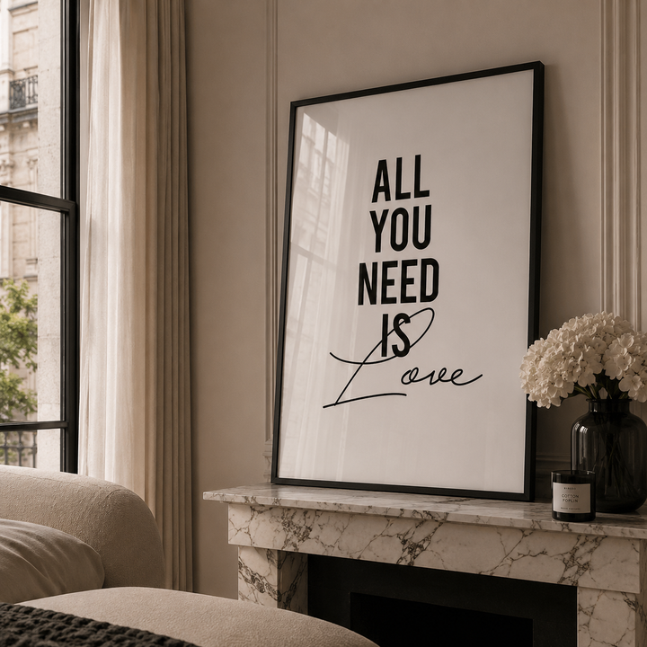 Framed artwork with 'All You Need Is Love' on a mantelpiece in a living room.