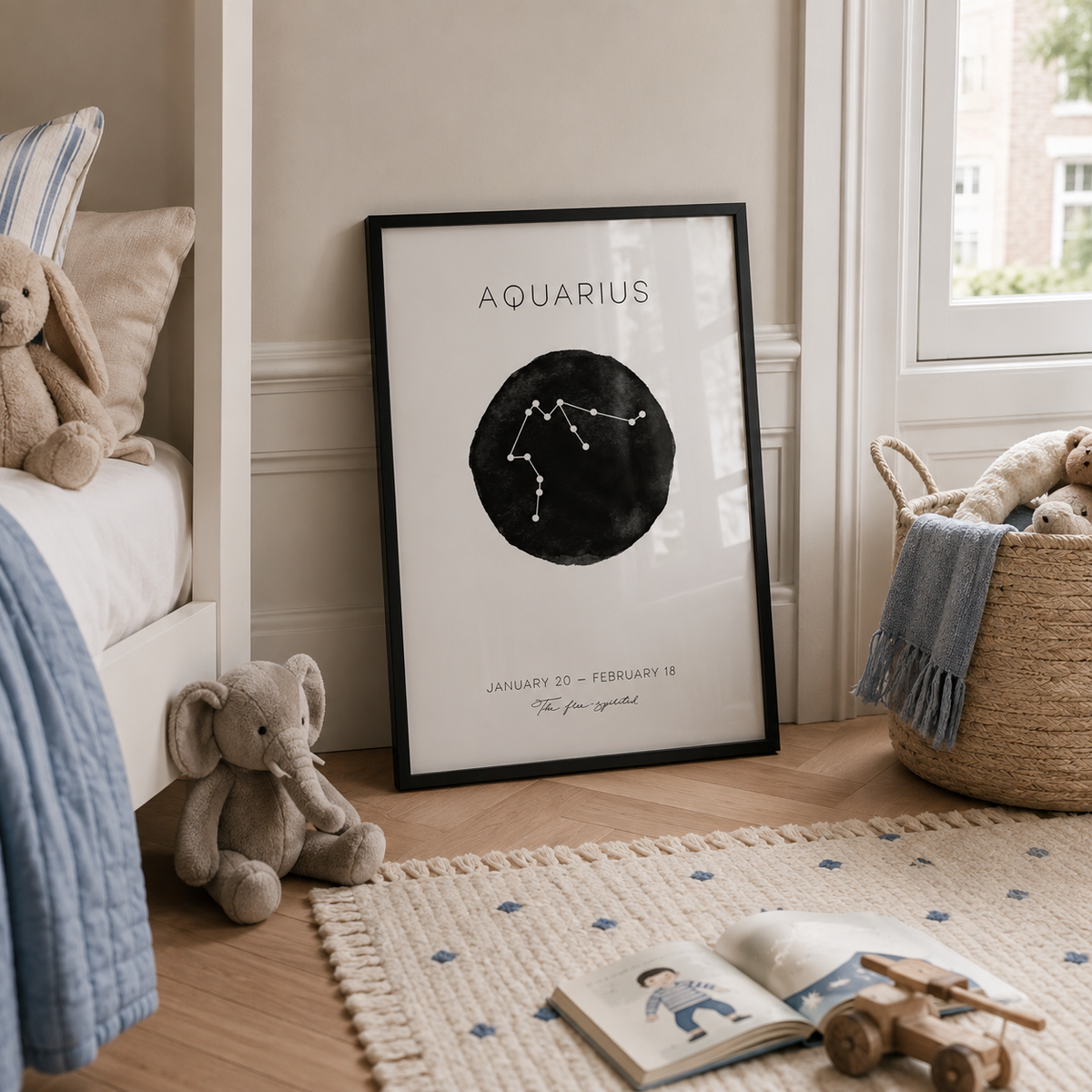 A framed black and white Aquarius zodiac sign print leaning against a wall in a styled nursery or children's room, surrounded by toys, a basket, and a window.